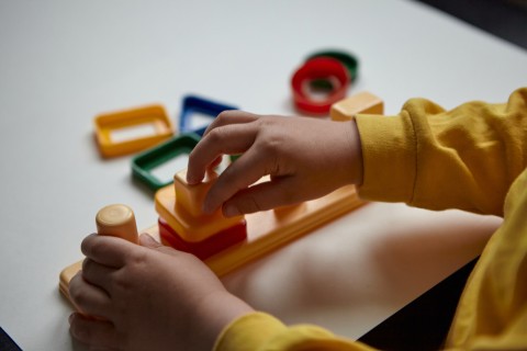 Child's hand playting with shapes